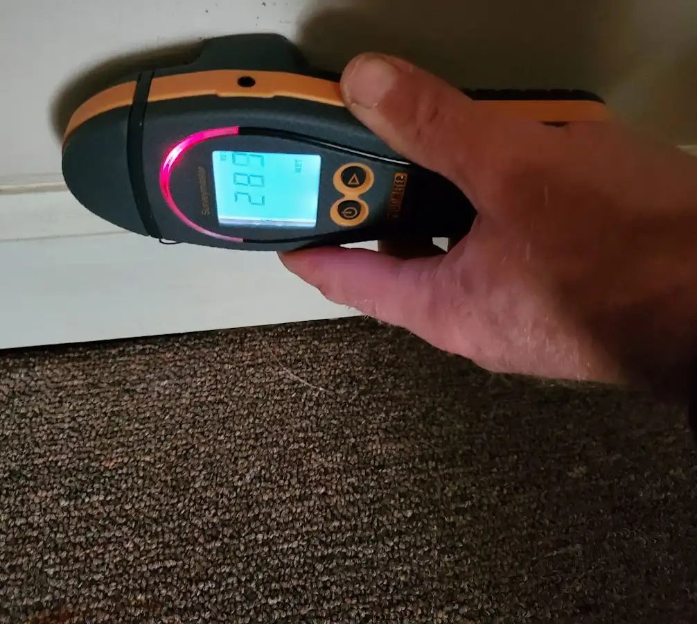 Moisture detection at baseboard during Storm Damage Restoration in St. Cloud